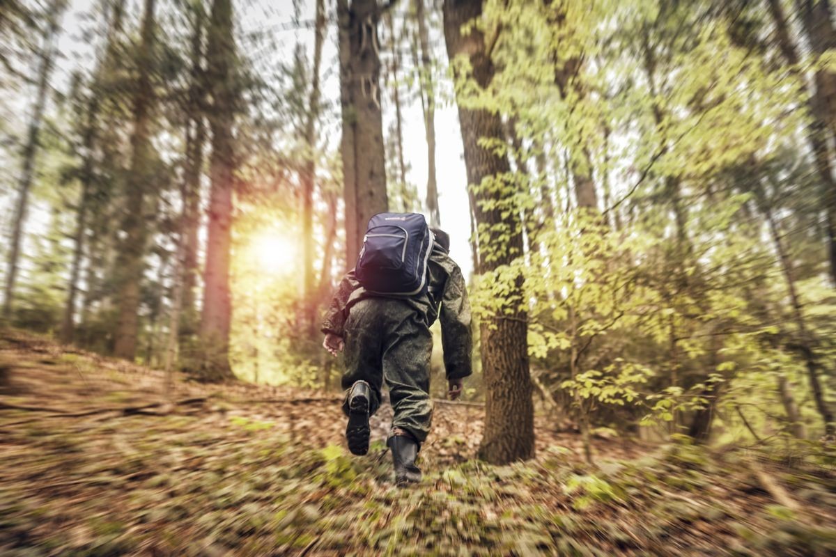 Young man hiking outdoor  in the forest 